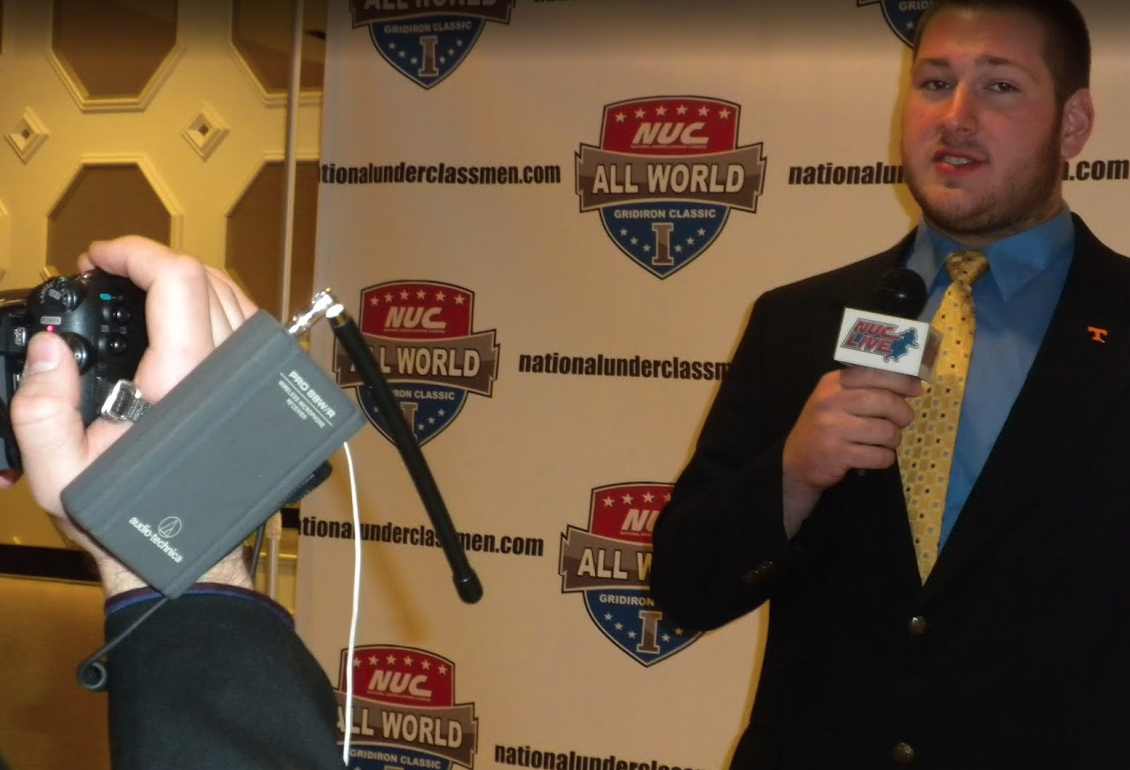 NUC All World player being interviewed on camera at the press backdrop