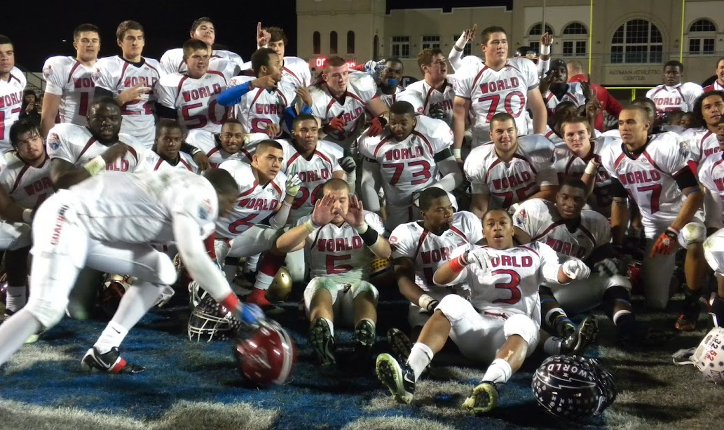 All World team group photo celebrating together under the lights