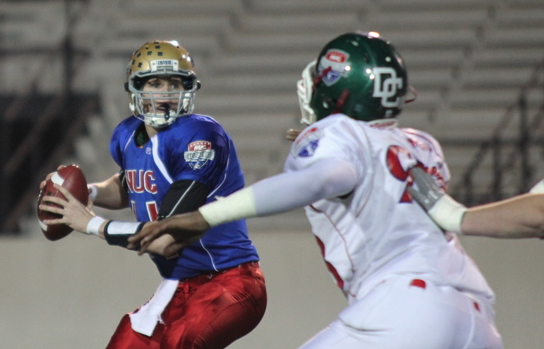 All American quarterback scanning the field under pressure during live play