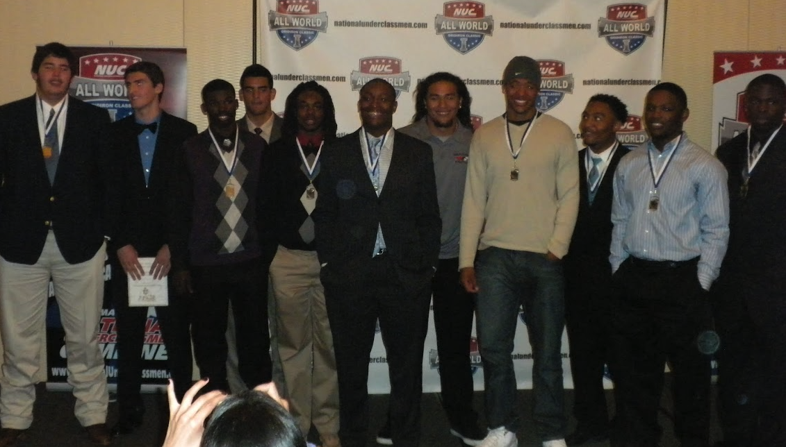 All World banquet group photo with medal winners in front of the backdrop