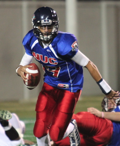NUC All American ball-carrier sprinting in blue jersey during game action