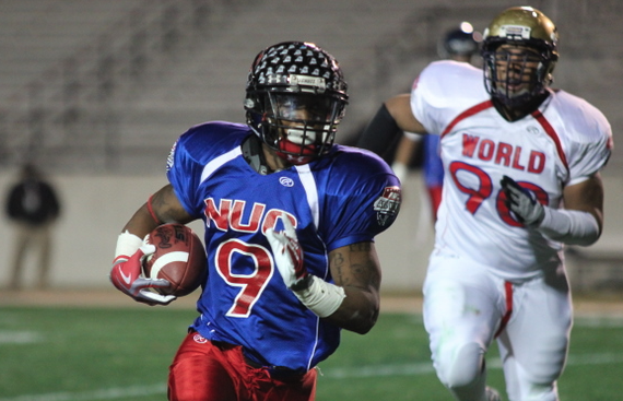 NUC runner breaking into the open field with a defender chasing behind