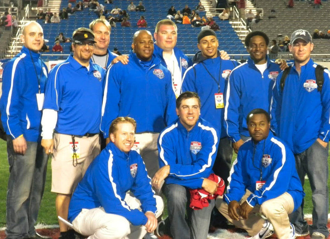 NUC coaching staff posing together on the field before the game
