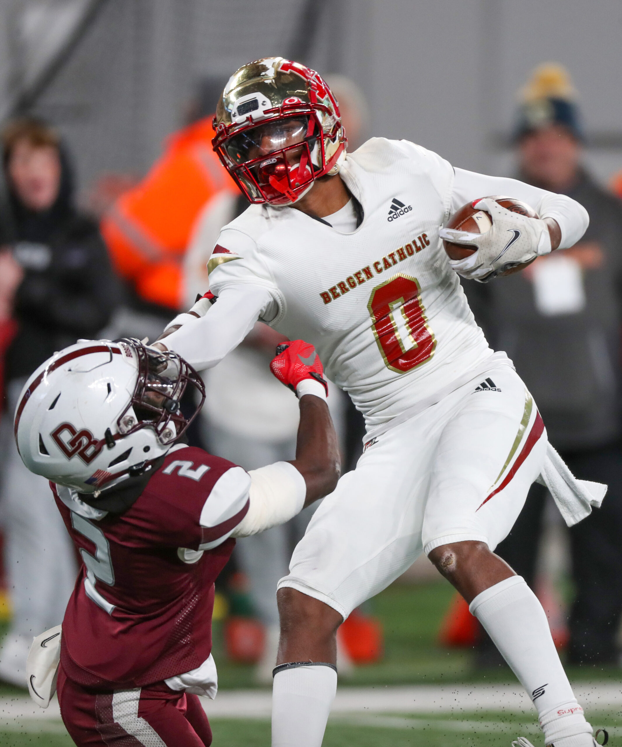 Quincy Porter (0) of Bergen Catholic stiff arms Sheaquan Walters (2) of Don Bosco Prep to the turf after Porter made a a catch during the second quarter of the NJSIAA non-public A state final on Friday, Nov. 25, 2022 in East Rutherford, N.J.