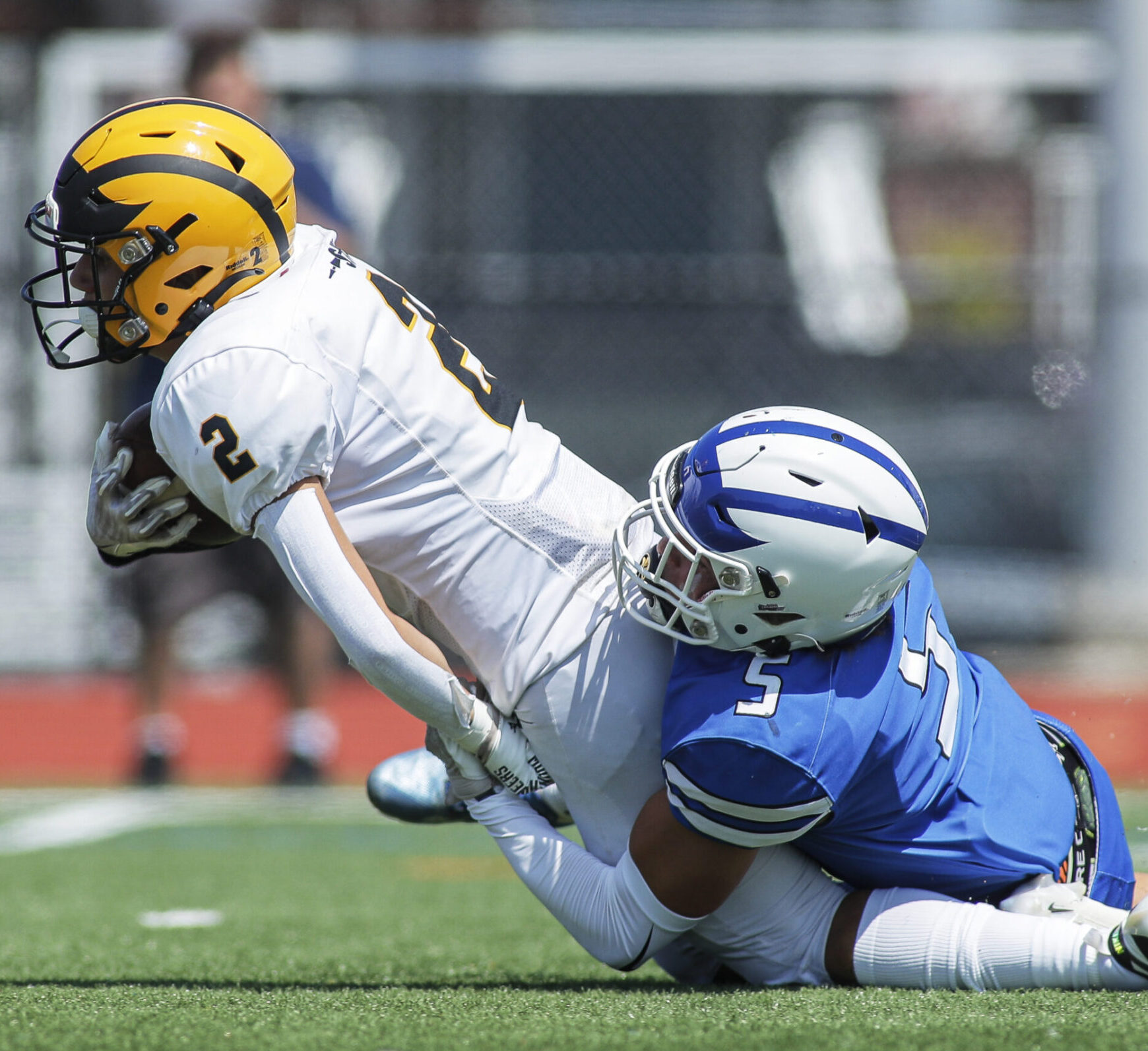 Dante Campagna (2) of St. John Vianney is dragged down by Justin Doughty (5) of Hammonton during the Battle at the Beach football game between Hammonton and St. John Vianney at Ocean City High School in Ocean City, NJ on Friday, August 25, 2023.